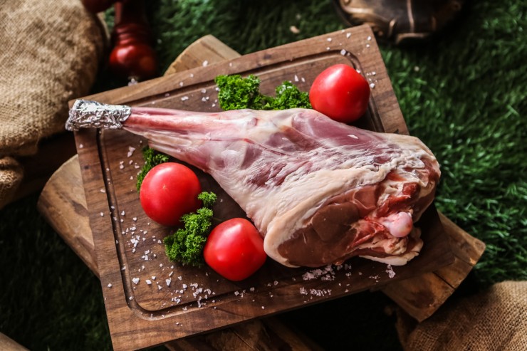 lamb-leg-wooden-board-prepared-cook-tomato-broccoli-salt-top-view