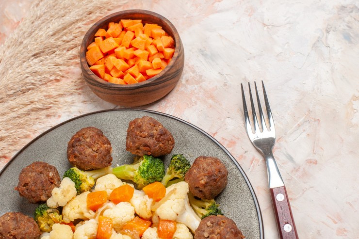 front-view-broccoli-cauliflower-salad-meatball-plate-bowl-with-cutting-carrot-fork-nude-background-with-copy-space