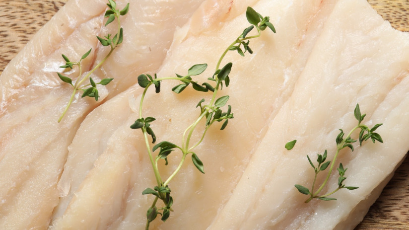 board-with-raw-cod-fish-microgreens-products-grey-table-flat-lay