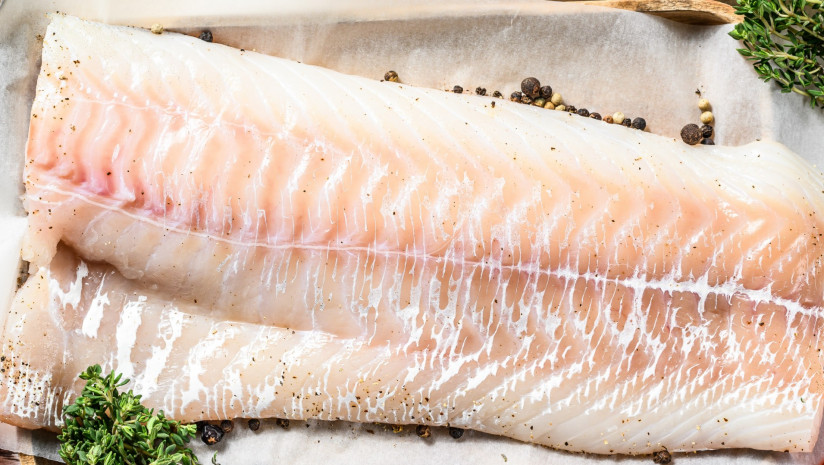 raw-cod-fillet-herbs-wooden-cutting-board