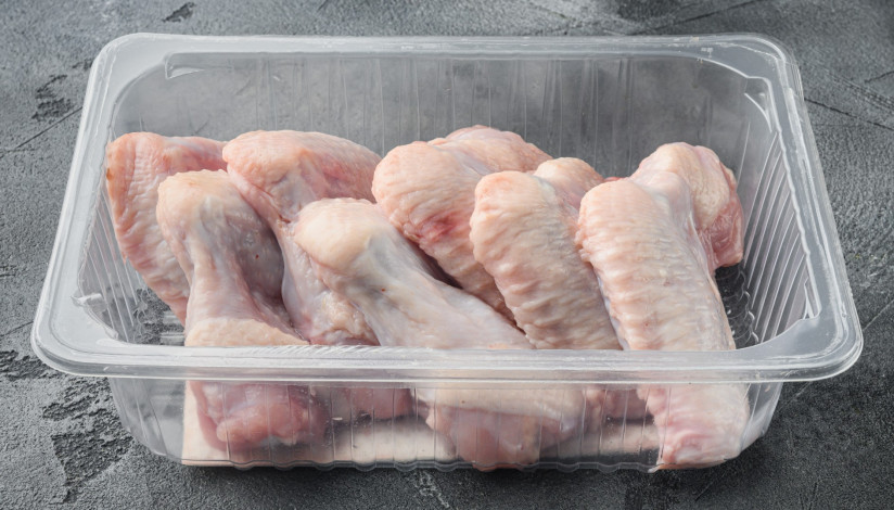 fresh-chicken-wings-spit-plastic-vacuum-pack-set-gray-stone-background
