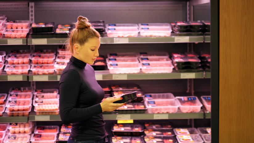 woman-purchasing-packet-meat-supermarket