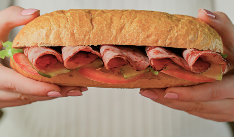 holding-sandwich-with-meat-vegetables-restaurant (1)