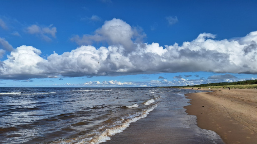 waves-crashing-sandy-beach-cloudy-blue-sky (1)