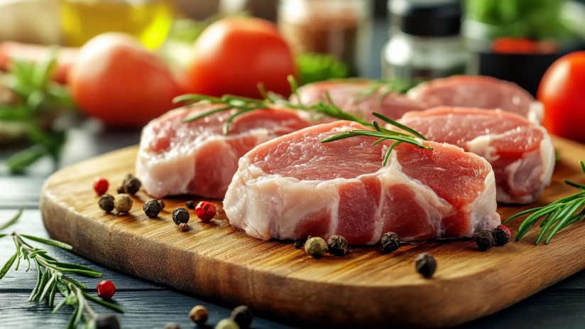 raw-pork-chops-seasoned-with-rosemary-peppercorns-wooden-board